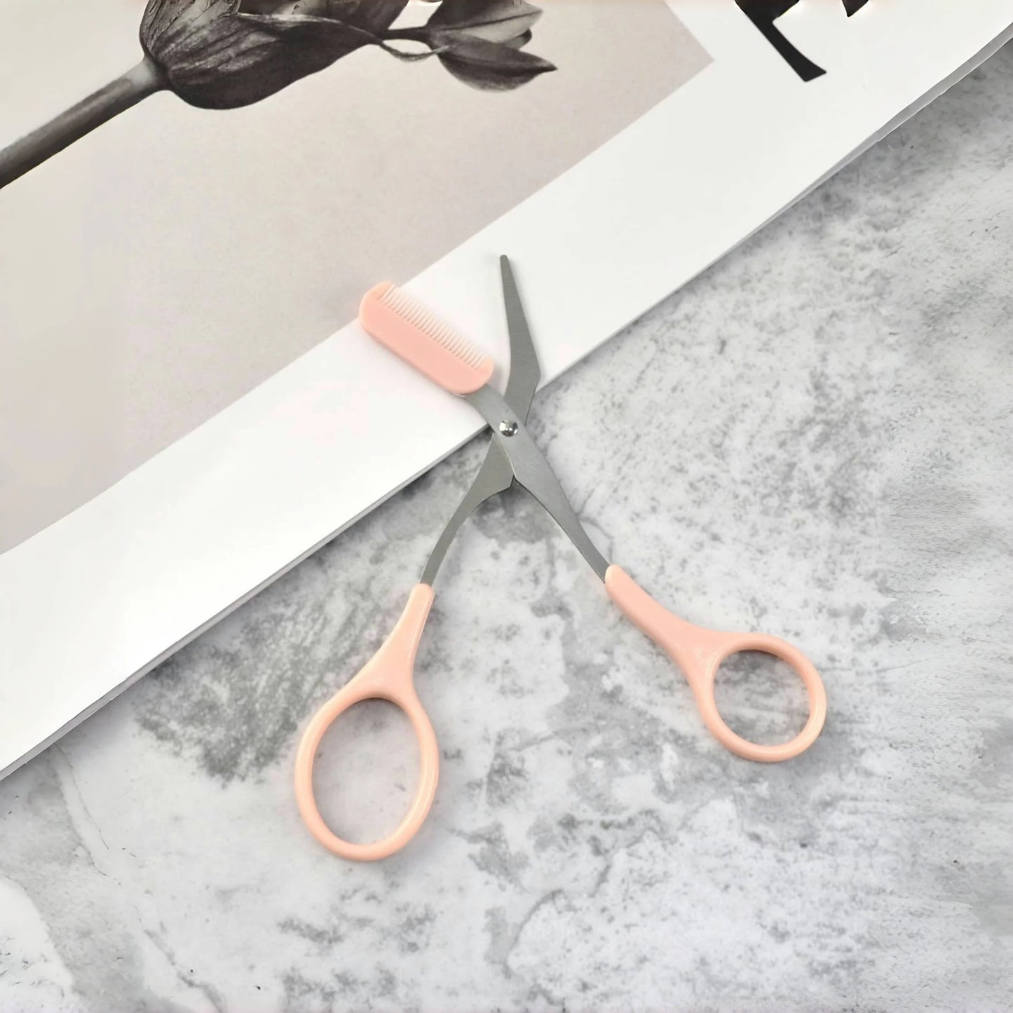 Pink eyebrow scissors with built-in comb