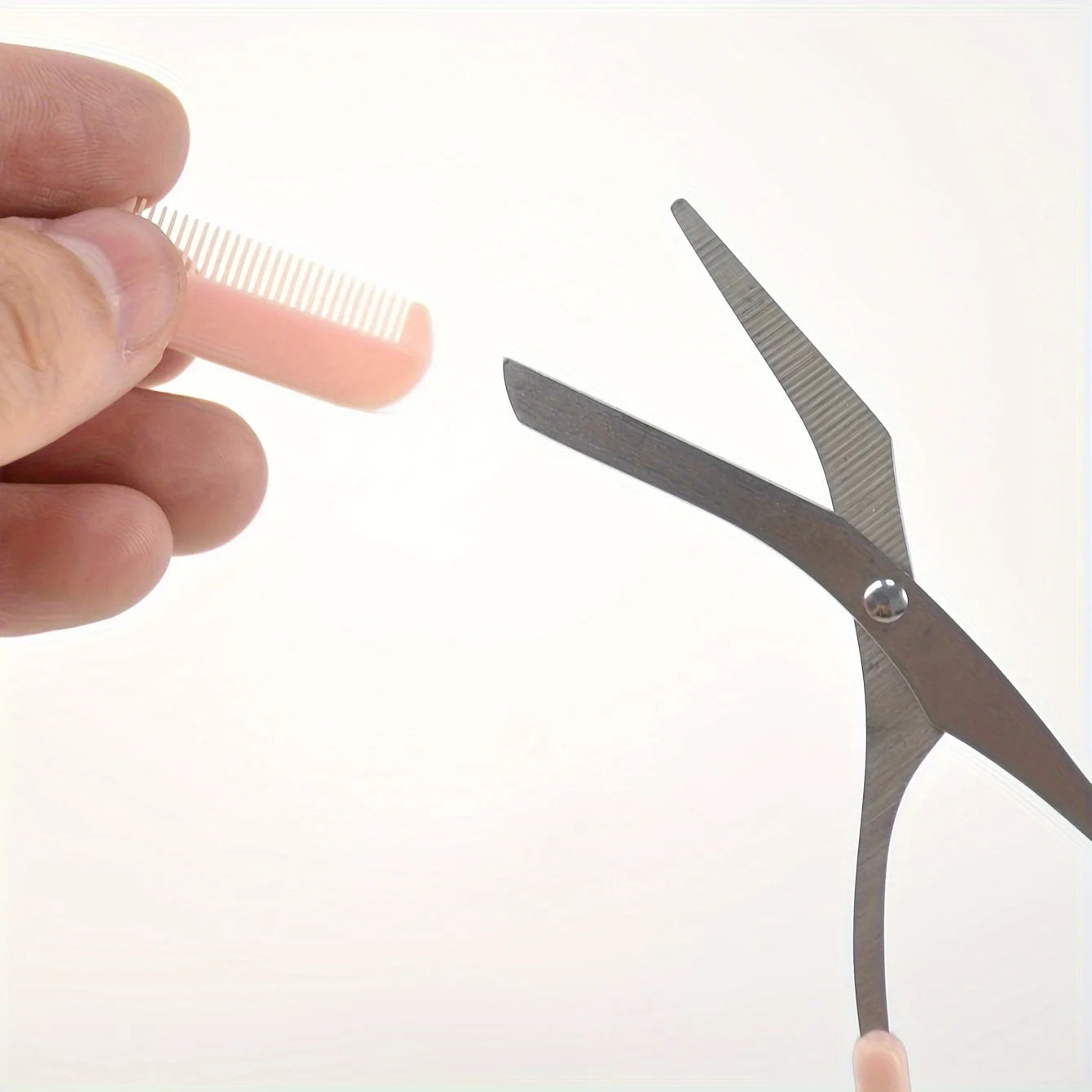 Pink eyebrow scissors with built-in comb